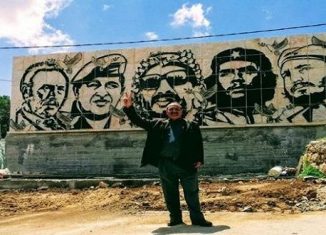 El muro, de 10 metros de ancho por 3 alto, fue hecho sobre piedra en la cumbre más alta de la localidad de Dora. En la obra figuran los rostros de líderes revolucionarios como Fidel Castro, Ernesto Che Guevara y Hugo Chávez, entre otros.